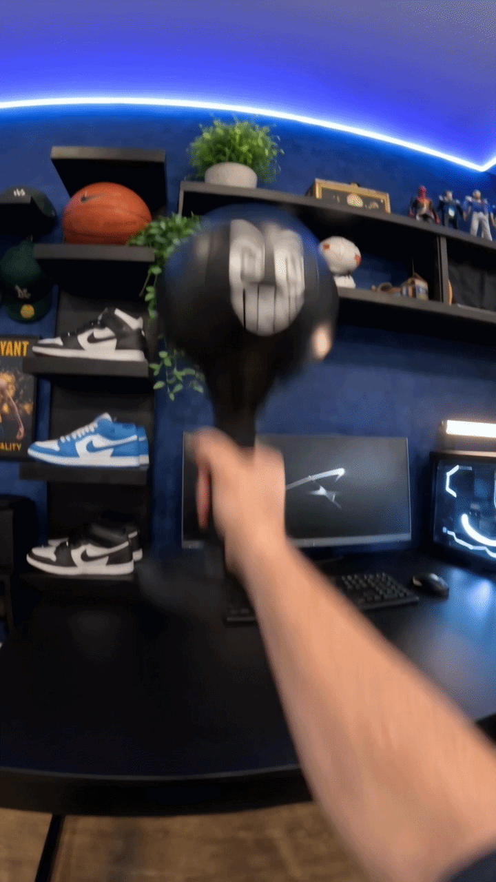 TiltBag desktop punching bag beside a gaming setup